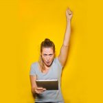 Lady Winning on iPad with Yellow Background