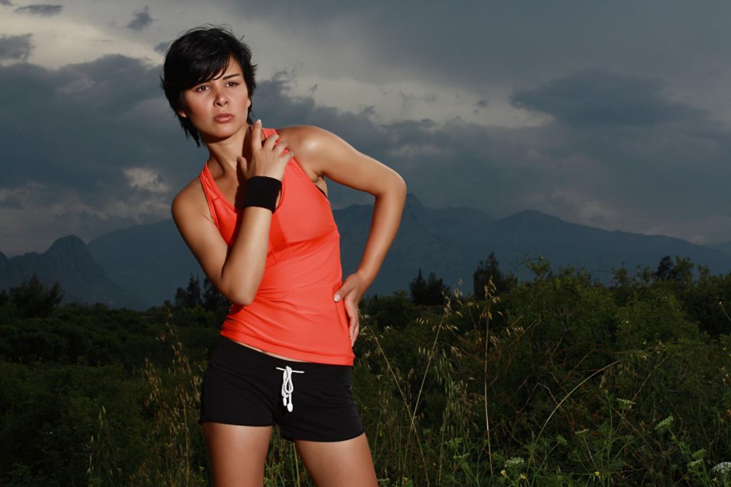 Woman in Orange and Black Sports Clothes Posing