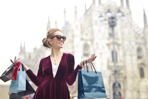 Stylish Smiling Woman in Town with Designer Shopping Bags