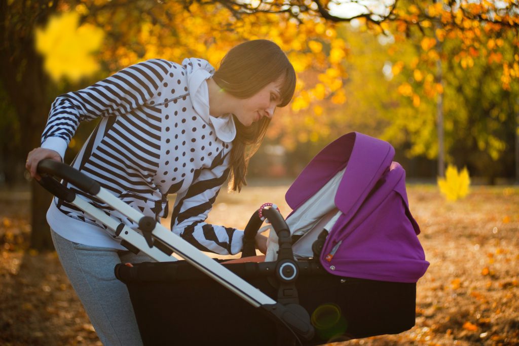 Woman Looking at Her Baby In Pram