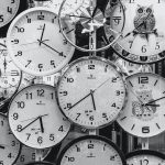 Wall of Many Overlapping Black and White Clocks