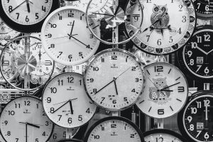 Wall of Many Overlapping Black and White Clocks