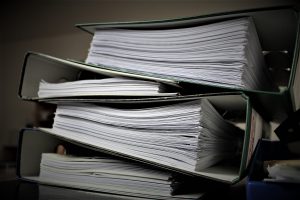 Side View of Documents in Black Ring Binders